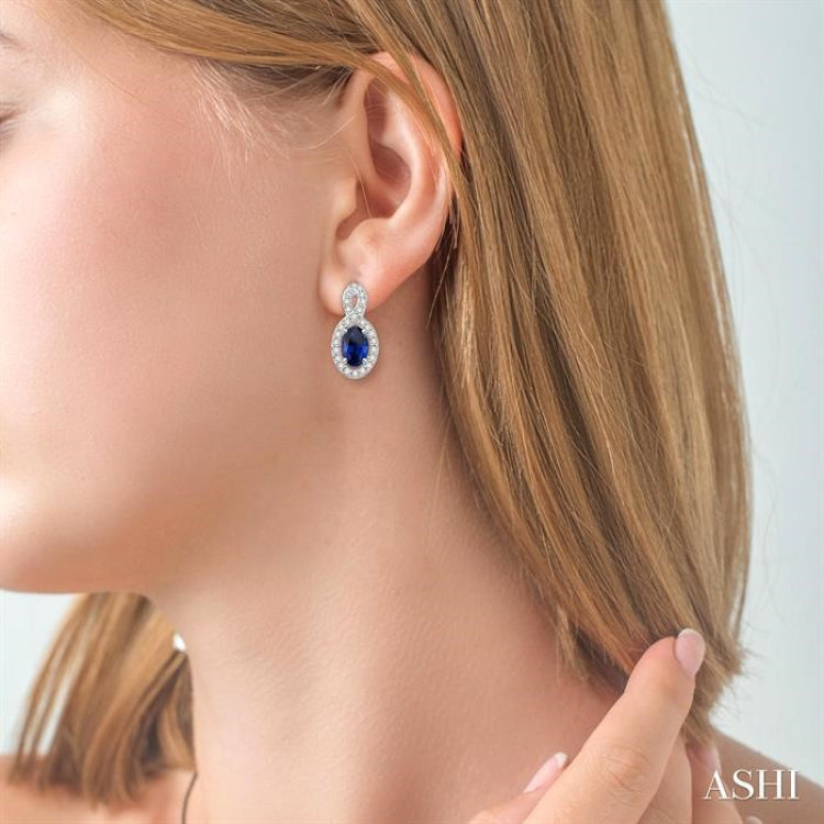 5x3 MM Oval Cut Sapphire and 1/5 ctw Round Cut Diamond Earrings in 14K White Gold