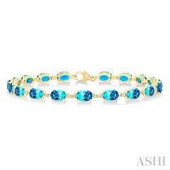 6X4 MM Oval Cut Blue Topaz and 1/6 Ctw Round Cut Diamond Semi-Precious Tennis Bracelet in 10K Yellow Gold