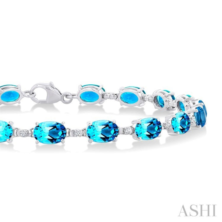 6X4 MM Oval Cut Blue Topaz and 1/6 Ctw Round Cut Diamond Semi-Precious Tennis Bracelet in 10K White Gold