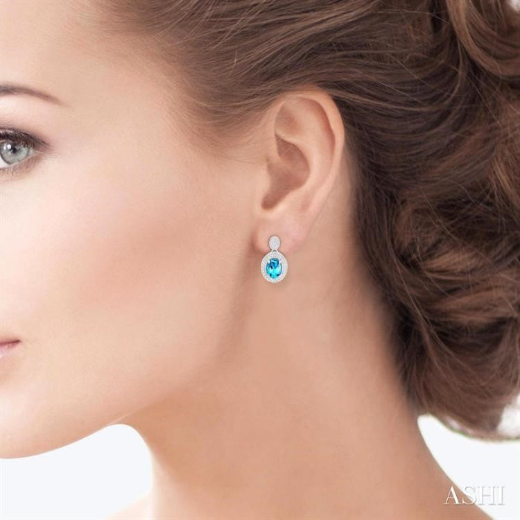 7X5 MM Oval Cut Blue Topaz and 1/20 Ctw Round Cut Diamond Semi-Precious Earrings in Sterling Silver